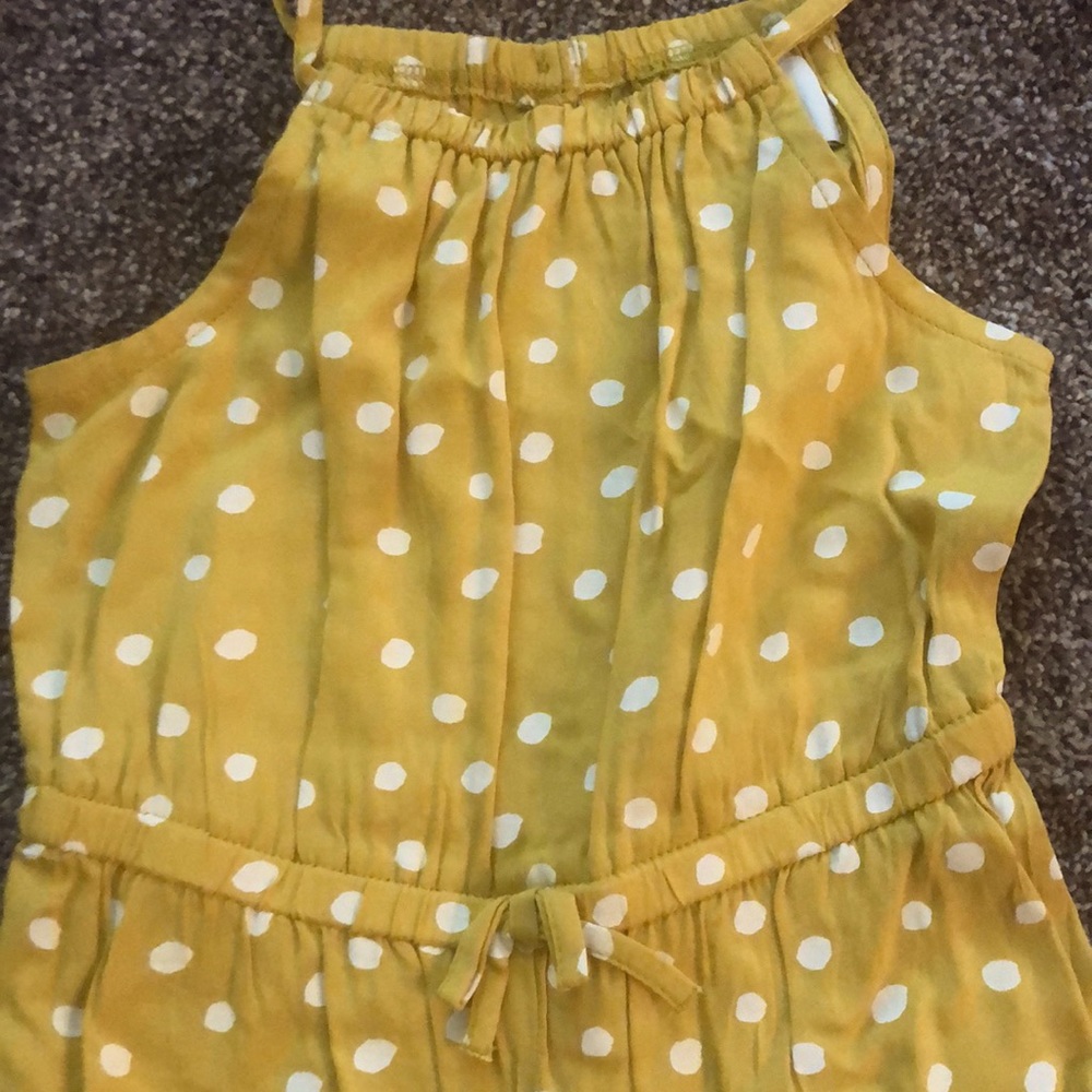 Yellow and white polka dot baby romper. Snap leg. semi cinch elastic details.